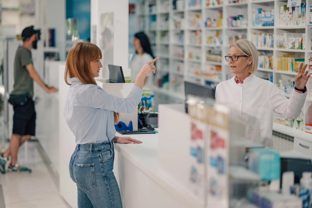 Patient speaking with a pharmacist at the counter